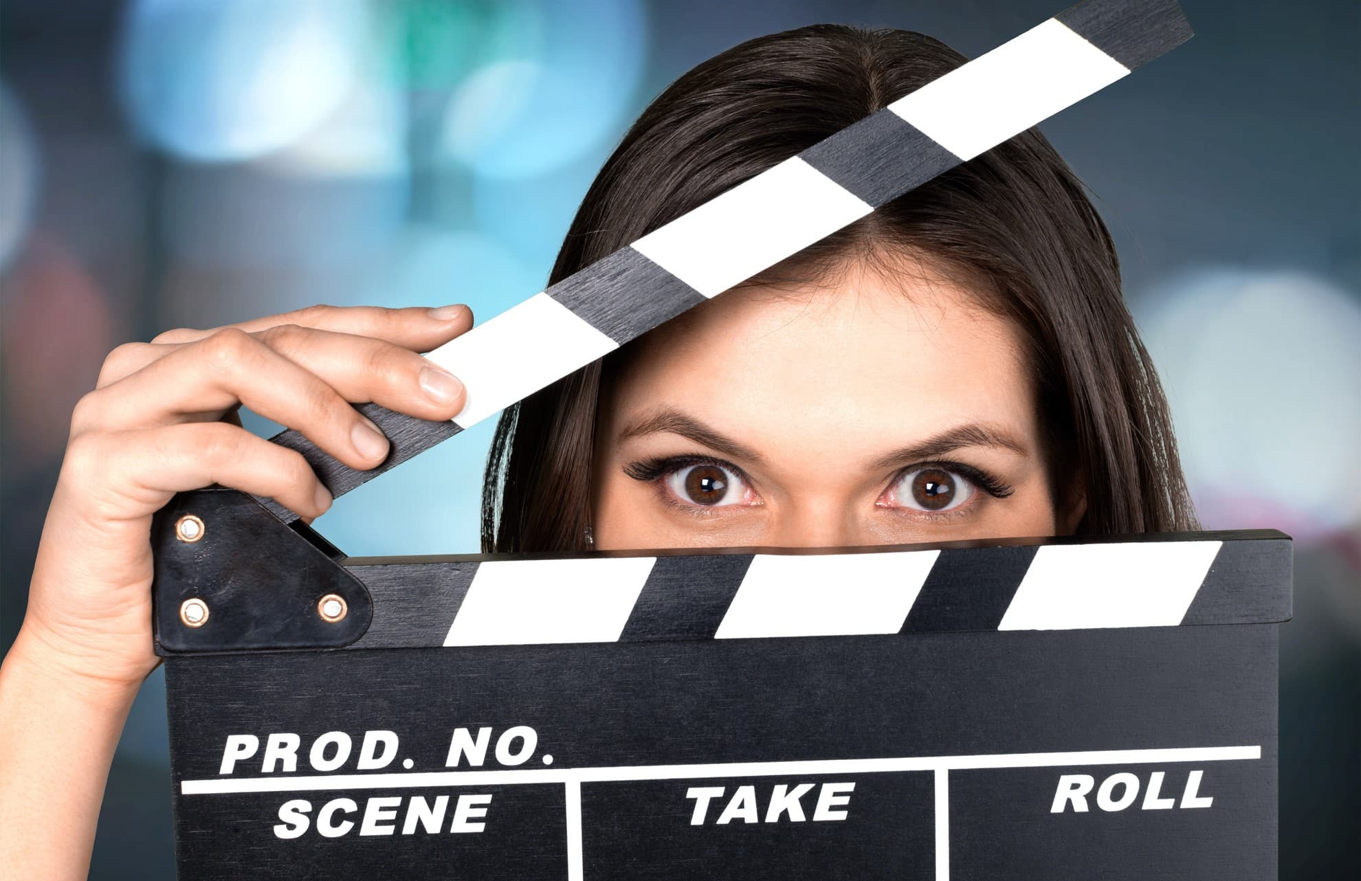 A woman holding a filmboard to highlight video ad length