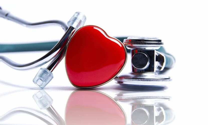 A close up of a stethoscope and plastic heart