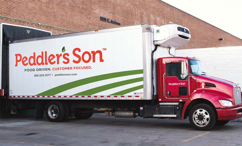 A Peddler's Son Delivery truck parked outside of the facility