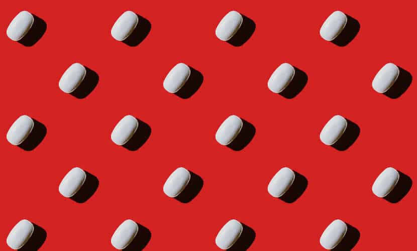 A row of white pills highlighting advertising in healthcare
