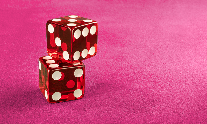 Two Red Dice On A Pink Casino Table