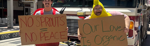 James And Michael Dressed As Fruit Holding Up Signs